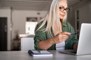 Woman completes an online payment with her card.