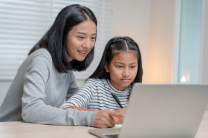 Mother teaches young daughter the basics of saving money.