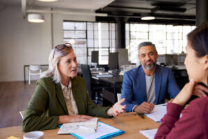 Financial advisor meets with young woman to discuss investments.