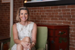 Sallie Krawcheck, co-founder and CEO of Ellevest, sits and smiles in Erika Kullberg's podcast studio.
