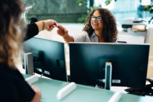 Teller assisting a woman at her neighborhood credit union branch.