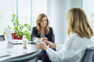 A woman meets with a financial advisor to discuss her investment account.