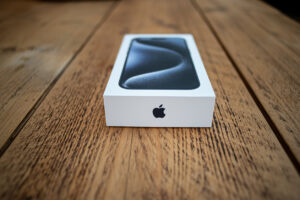 New iPhone in its box on a wooden table.