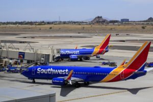 Two Southwest airplanes parked at their gates.