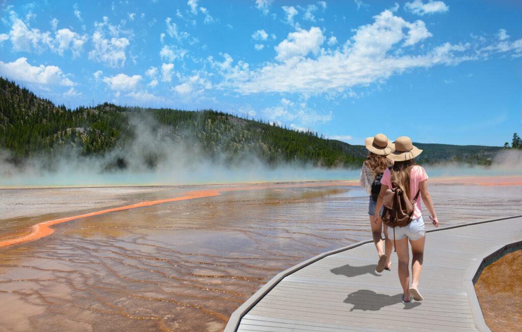 - Erika Kullberg Two young girls walking along the trail beside the Grand Prismatic hot spring