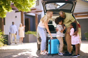 Family loads up the car after a road trip to see family.