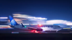 A United Airlines flight landing at night
