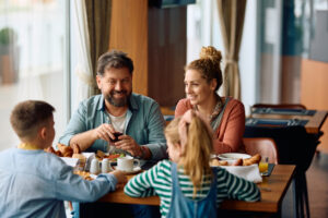 Happy family talking while having breakfast in a restaurant