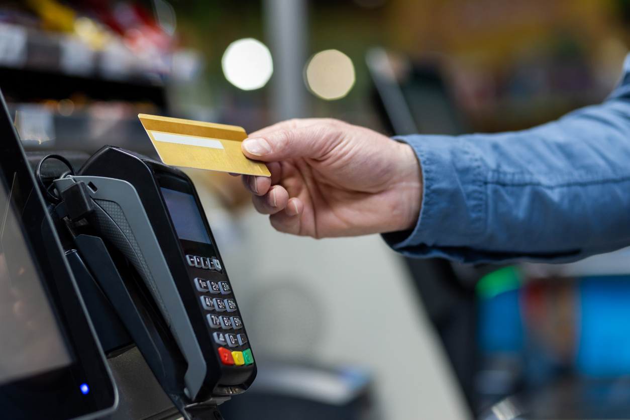 Person using credit card at a contactless payment terminal