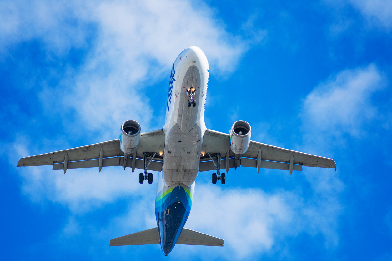 View underneath an Alaska Airlines aircraft preparing for landing