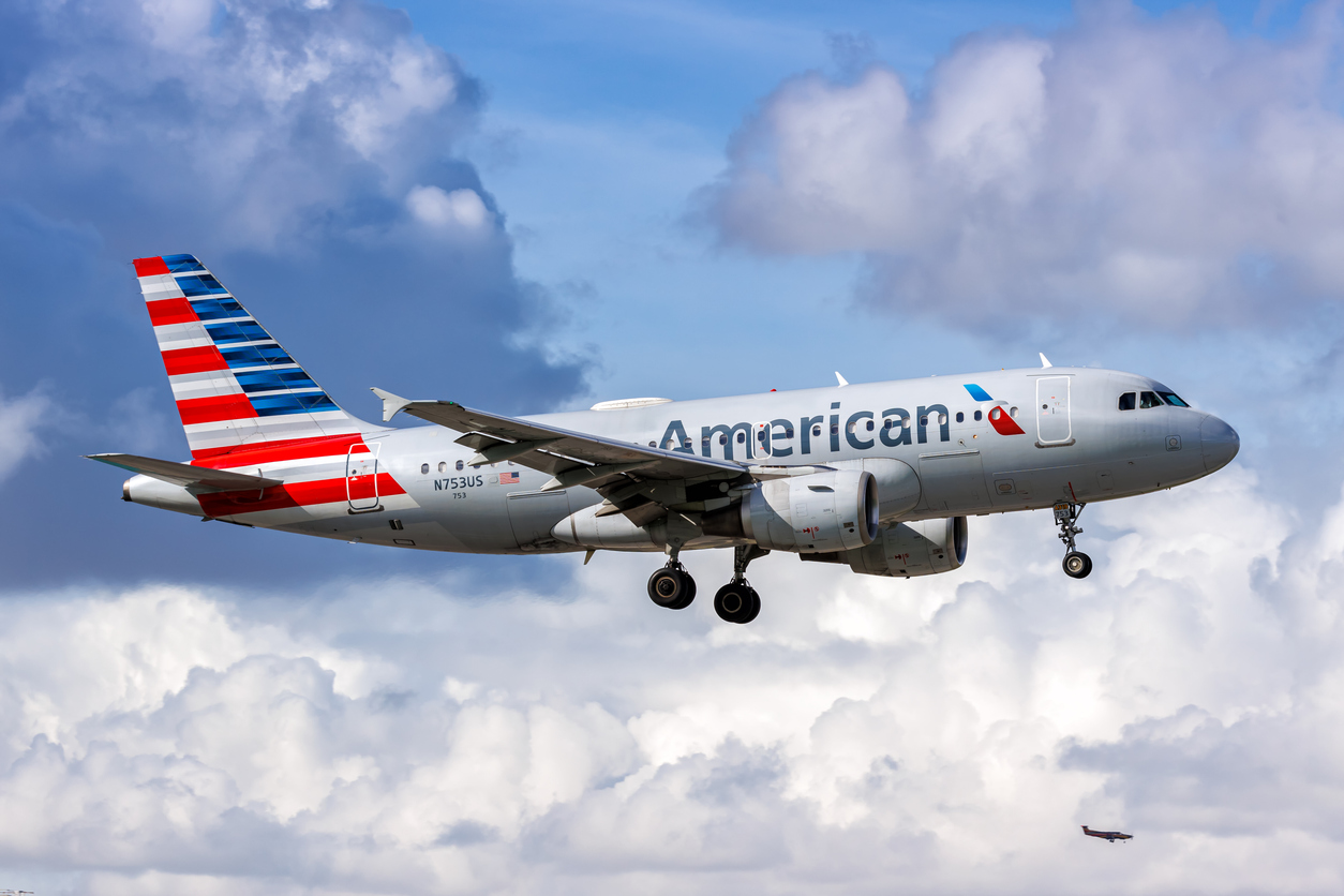 An American Airlines flight in the sky against white clouds