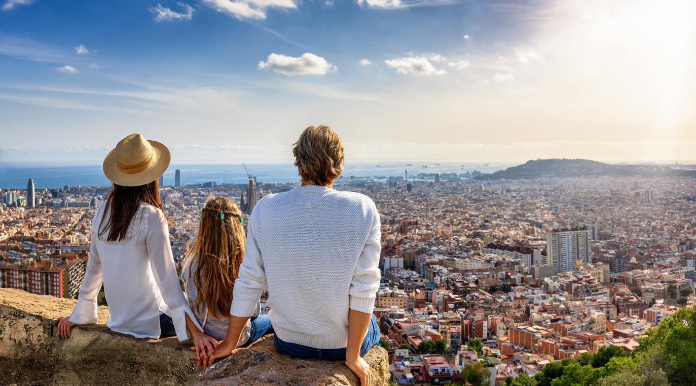 A family enjoys the panoramic view of the skyline of Barcelona