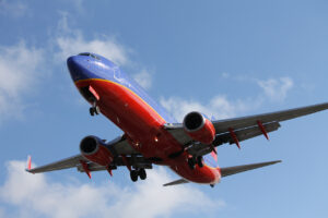 A Southwest airplane taking off into a blue sky