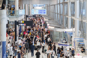 busy_airport_crowd_travel - Erika Kullberg Overhead shot of a busy crowd of people in the airport.